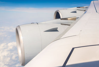 Close-up of airplane wing against sky