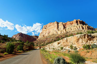 Scenic view of mountains against blue sky