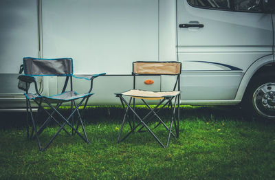 Empty chairs and tables on field