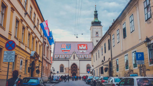 View of city street and buildings against sky