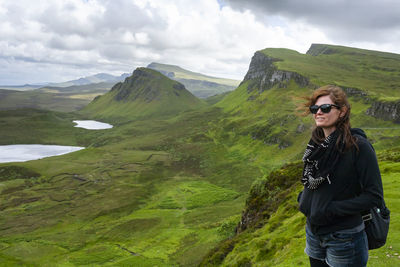 Woman looks out at the dramatic view in quiraing isle of skye scotland