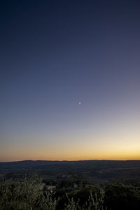 Scenic view of landscape against clear sky at night