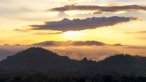 Scenic view of silhouette mountains against sky at sunset