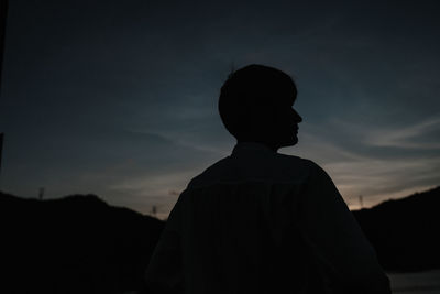 Silhouette man standing against sky during sunset