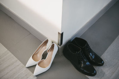 High angle view of shoes on floor by wall