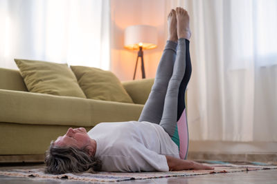 Woman sitting on sofa at home