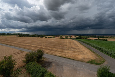 Scenic view of agricultural field against sky