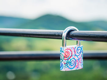 Close-up of padlocks on railing