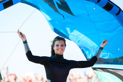 Low angle view of woman holding umbrella