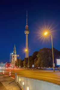 The famous television tower of berlin and the church of st. mary at night