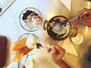 High angle view of woman holding food on table