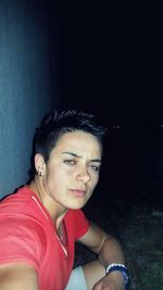 Portrait of young woman sitting outdoors