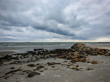 Rocks on beach against sky