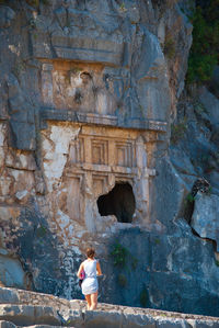 Low angle view of woman walking against historic building