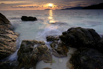 Scenic view of sea against sky at sunset