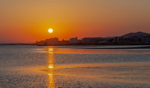 Scenic view of sea against orange sky during sunset