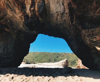 Scenic view of sea seen through cave