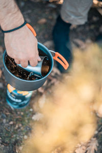 High angle view of man holding cigarette
