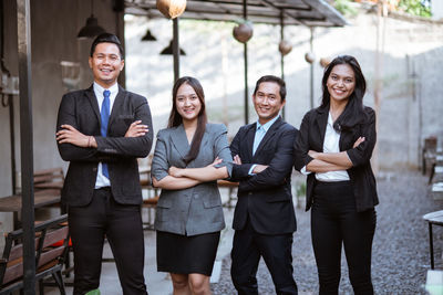 Portrait of business colleagues standing in city