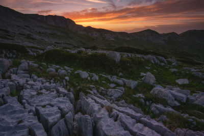 Scenic view of rocky mountains against sky during sunset