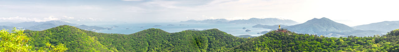 Panoramic view of trees and mountains against sky