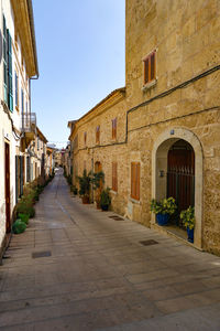 Empty road amidst buildings in town