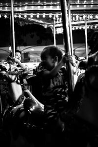 Illuminated carousel in amusement park