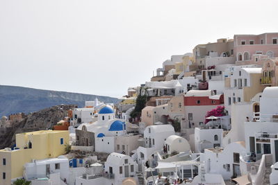 Buildings in city against clear sky