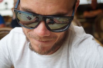 Close-up portrait of man wearing sunglasses