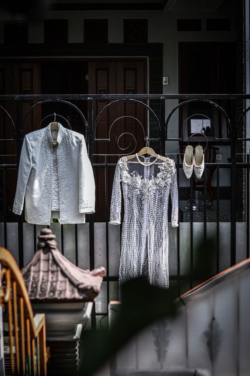 ROW OF CLOTHES HANGING IN STORE OUTSIDE BUILDING