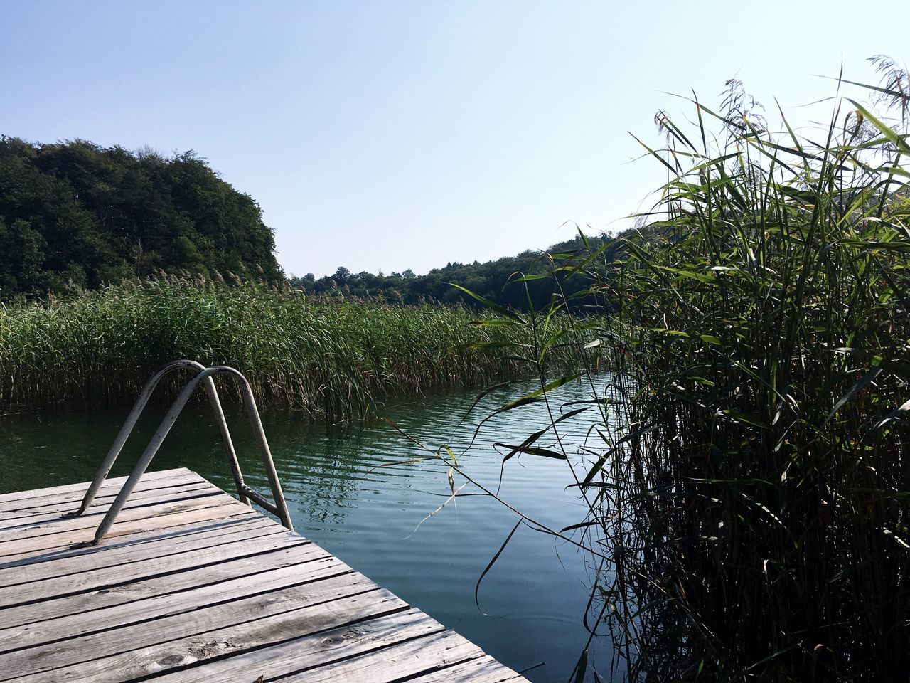 VIEW OF FOOTBRIDGE OVER CALM SEA