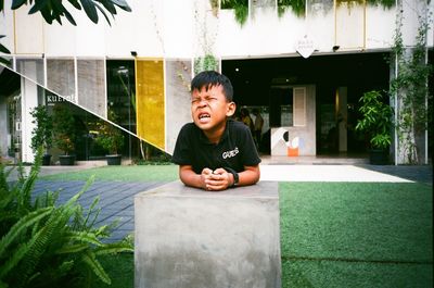 Portrait of boy sitting outdoors