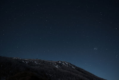 Low angle view of mountain against sky at night