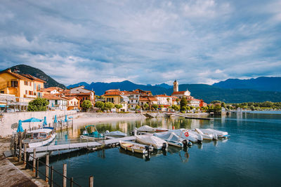 Buildings in town against cloudy sky