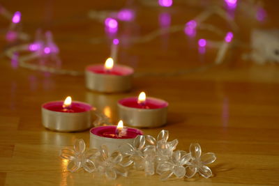 Close-up of lit candles on table