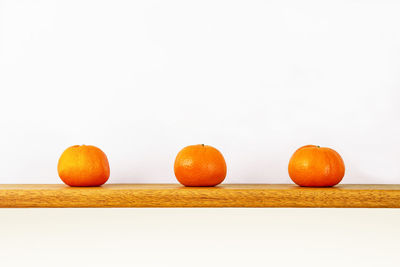 Close-up of orange fruits against white background