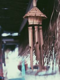 Low angle view of electric lamp hanging on roof