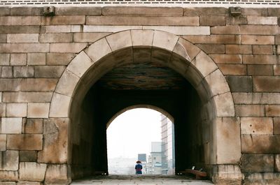 Man seen through archway