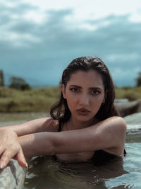 Portrait of beautiful woman against sky