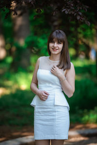 Portrait of a smiling young woman standing outdoors