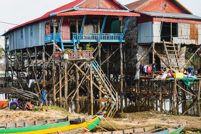 Group of people in traditional house by building