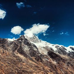 Low angle shot of rocky landscape against blue sky