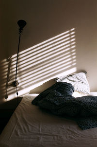 Electric lamp on table against wall at home