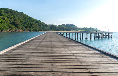 Surface level of swimming pool by sea against sky