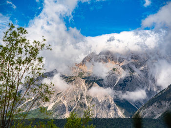 Low angle view of snowcapped mountains against sky