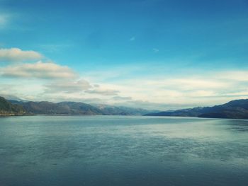 Scenic view of mountains against cloudy sky