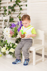 Full length of cute girl holding flower pot