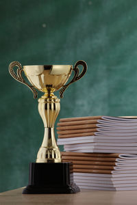 Close-up of trophy by books