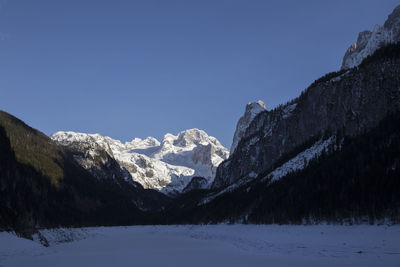 Snowcapped mountains against clear blue sky