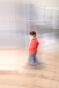 Boy playing on hardwood floor